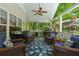 Relaxing back porch with ceiling fan and comfortable outdoor seating, plus a grill and backyard view at 4010 Tamarack Nw Dr, Kennesaw, GA 30152
