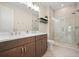 Contemporary bathroom with double sink vanity, glass enclosed shower, and neutral tile at 720 Tannery Cmn, Alpharetta, GA 30009