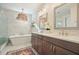 Bathroom featuring a glass enclosed shower, standalone tub, a double vanity, and a decorative hanging light fixture at 720 Tannery Cmn, Alpharetta, GA 30009