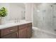 Modern bathroom showcasing a glass-enclosed shower, sleek vanity, and neutral tile at 720 Tannery Cmn, Alpharetta, GA 30009
