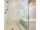 Bathroom featuring a glass shower, bathtub, with elegant fixtures and neutral color palette, creating a luxurious spa-like experience at 720 Tannery Cmn, Alpharetta, GA 30009
