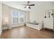 Bright bedroom with hardwood floors and daybed, illuminated by natural light from a large window at 720 Tannery Cmn, Alpharetta, GA 30009