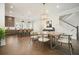 Bright dining area with view into kitchen and staircase; open floor plan with hardwood floors at 720 Tannery Cmn, Alpharetta, GA 30009