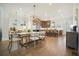 Dining area with modern chandelier, hardwood floors, and an open layout to kitchen at 720 Tannery Cmn, Alpharetta, GA 30009