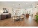 Spacious dining room with hardwood floors, stylish lighting, and open access to the living room at 720 Tannery Cmn, Alpharetta, GA 30009