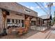 Brick commercial building with outdoor seating and signage, creating an inviting entrance at 720 Tannery Cmn, Alpharetta, GA 30009