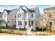 Charming two-story home with white siding, black framed windows and a well-manicured front yard in a desirable neighborhood at 720 Tannery Cmn, Alpharetta, GA 30009