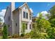 Striking two-story home with white siding, prominent chimney, and lush landscaping at 720 Tannery Cmn, Alpharetta, GA 30009