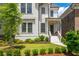 Inviting two-story home featuring a charming front porch and well-manicured landscaping at 720 Tannery Cmn, Alpharetta, GA 30009