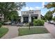 Charming white brick building with outdoor patio seating and decorative landscaping at 720 Tannery Cmn, Alpharetta, GA 30009