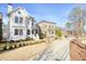 A beautiful white two-story home with manicured lawn and sidewalk in a picturesque neighborhood at 720 Tannery Cmn, Alpharetta, GA 30009