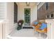 Inviting front porch with chairs, stylish door and colorful plants create a relaxing outdoor space at 720 Tannery Cmn, Alpharetta, GA 30009