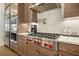 Gourmet kitchen featuring stainless steel appliances, custom cabinetry, and a modern backsplash at 720 Tannery Cmn, Alpharetta, GA 30009