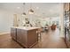 Open concept kitchen with island, hardwood floors, and views of the dining and living areas at 720 Tannery Cmn, Alpharetta, GA 30009