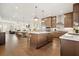 Open concept kitchen with stainless appliances and hardwood floors, flowing into the dining and living areas at 720 Tannery Cmn, Alpharetta, GA 30009