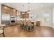 Modern kitchen with stainless steel appliances, granite countertops, and a center island with bar stools at 720 Tannery Cmn, Alpharetta, GA 30009