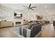 Open-concept living room features a fireplace, wood floors, and views into the kitchen and dining area at 720 Tannery Cmn, Alpharetta, GA 30009