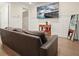 Cozy living room with a plush brown sofa, stylish decor, and elegant wainscoting at 720 Tannery Cmn, Alpharetta, GA 30009