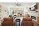 Bright living room features a modern ceiling fan, fireplace, and comfortable seating for entertaining or relaxing at 720 Tannery Cmn, Alpharetta, GA 30009