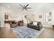 Open-concept living room with modern ceiling fan, hardwood floors, and comfortable seating at 720 Tannery Cmn, Alpharetta, GA 30009