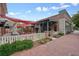 Inviting restaurant patio with comfortable seating, shaded by a stylish awning and surrounded by colorful landscaping at 720 Tannery Cmn, Alpharetta, GA 30009
