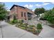 Unique restaurant building featuring landscaped gardens and artistic decor, enhancing its charm and street appeal at 720 Tannery Cmn, Alpharetta, GA 30009