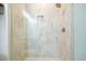 Close-up of shower featuring neutral tile, a built-in niche, and a rainfall showerhead at 720 Tannery Cmn, Alpharetta, GA 30009