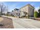 Street-level shot of neighborhood with sidewalks lined with new homes at 720 Tannery Cmn, Alpharetta, GA 30009