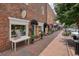 Street view of La Bella Maison in downtown Alpharetta, featuring storefront displays and sidewalk planters at 720 Tannery Cmn, Alpharetta, GA 30009