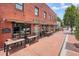 Street view of South Main Kitchen in downtown Alpharetta, featuring outdoor seating on a brick sidewalk at 720 Tannery Cmn, Alpharetta, GA 30009