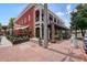 Street view of Fogón and Lions in downtown Alpharetta, featuring a red brick building with a covered patio at 720 Tannery Cmn, Alpharetta, GA 30009