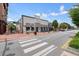 Street view of downtown Alpharetta with the Smokejack restaurant, exterior seating, and pedestrian crosswalk at 720 Tannery Cmn, Alpharetta, GA 30009