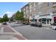 Street view of downtown Alpharetta with shops, cafes, and apartments featuring balconies and awnings at 720 Tannery Cmn, Alpharetta, GA 30009