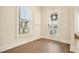 Bright sunroom with hardwood floors, a large window, and a glass door leading to an outdoor seating area at 720 Tannery Cmn, Alpharetta, GA 30009