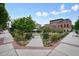 Landscaped walkway with colorful flowers and greenery leading to a building in a vibrant town square at 720 Tannery Cmn, Alpharetta, GA 30009