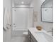 Bright bathroom featuring a shower-tub combination with marble floors and a modern vanity at 120 Pinecone Pkwy, Alpharetta, GA 30022
