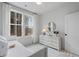 Serene bedroom with a daybed, windows overlooking a wooded area, and soft lighting at 120 Pinecone Pkwy, Alpharetta, GA 30022