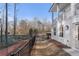 Rear view of white brick house showing fenced-in yard and wooded boundary at 120 Pinecone Pkwy, Alpharetta, GA 30022