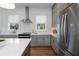 Stylish kitchen with gray cabinets, stainless steel appliances, quartz countertops, and modern lighting at 120 Pinecone Pkwy, Alpharetta, GA 30022