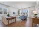 Bright and airy living room featuring hardwood floors, a blue sofa, and large windows with natural light at 120 Pinecone Pkwy, Alpharetta, GA 30022