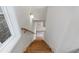 Wood staircase with natural light and a view into the main level at 120 Pinecone Pkwy, Alpharetta, GA 30022