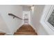 Modern staircase with wood stairs, white walls, and a window providing natural light at 120 Pinecone Pkwy, Alpharetta, GA 30022