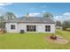 Backyard with a brick fire pit and a view of the home's exterior, offering a cozy outdoor entertainment space at 2006 Hawthorne Way, Woodstock, GA 30189