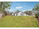 Expansive backyard with lush green lawn and mature trees, perfect for outdoor activities and relaxation at 2006 Hawthorne Way, Woodstock, GA 30189