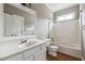 Bathroom features a large mirror, and a shower-tub combo with white tile at 2006 Hawthorne Way, Woodstock, GA 30189