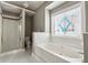 Bathroom features a large soaking tub and a separate shower with glass door at 2006 Hawthorne Way, Woodstock, GA 30189