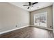 Cozy bedroom featuring hardwood floors, neutral walls, and a large window for natural light at 2006 Hawthorne Way, Woodstock, GA 30189