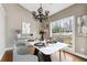 Dining room featuring modern chandelier, table setting and bright lighting at 2006 Hawthorne Way, Woodstock, GA 30189