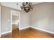 Neutral-toned dining room with hardwood floors, large window and chandelier at 2006 Hawthorne Way, Woodstock, GA 30189