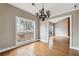 Dining room with hardwood floors, chandelier, and a large window for natural light at 2006 Hawthorne Way, Woodstock, GA 30189
